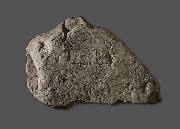Raised Relief Fragment with a Male Figure Grasping an Object Decorated with Representations of Non-Egyptians, Limestone