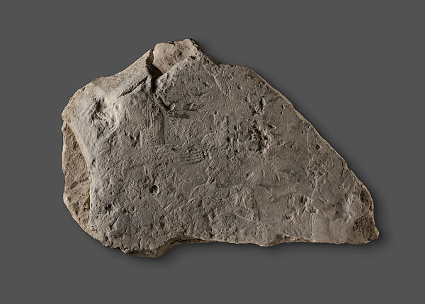 Raised Relief Fragment with a Male Figure Grasping an Object Decorated with Representations of Non-Egyptians, Limestone