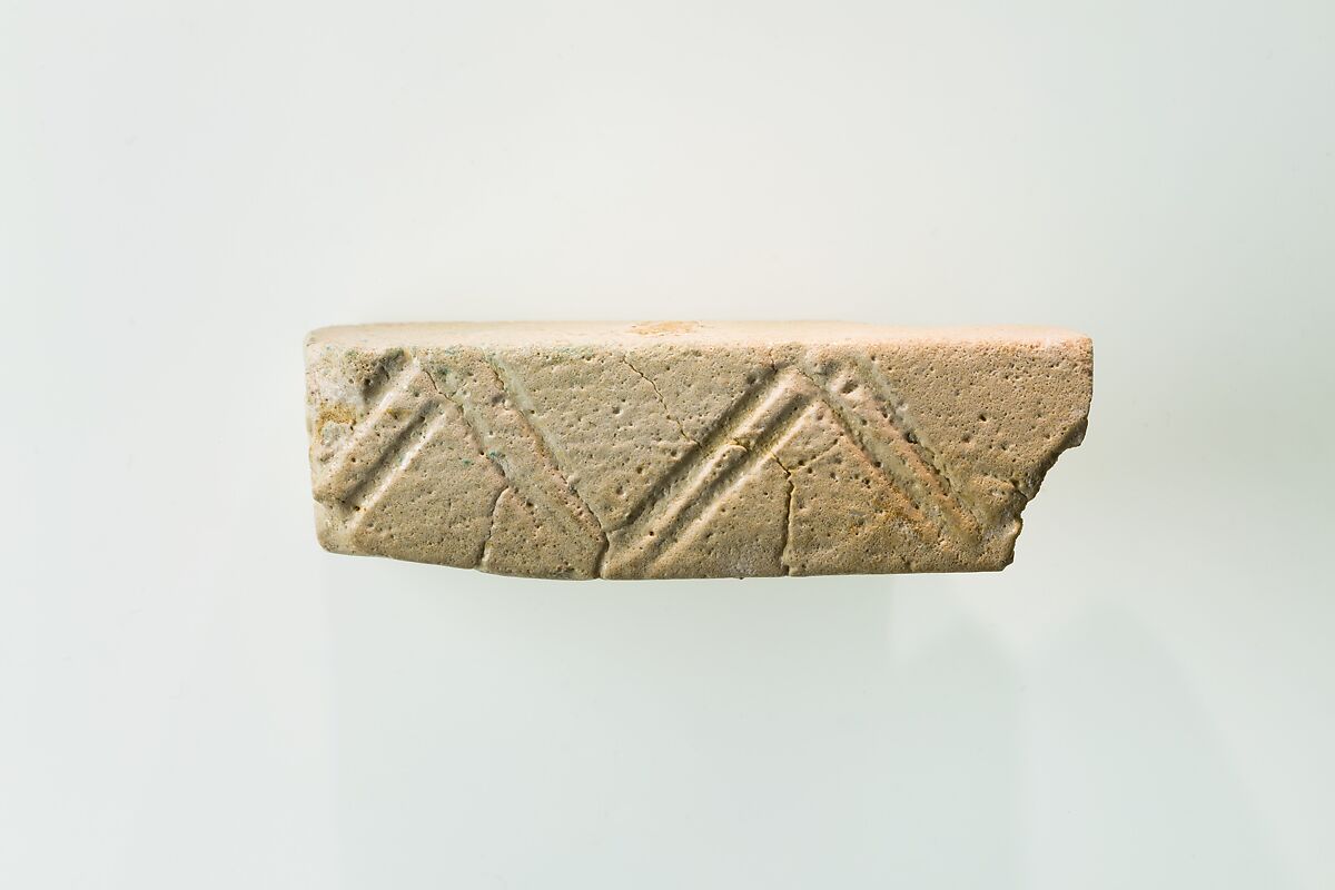 A fragment of a cubic unknown object, possibly a fragment of a rod, White faience