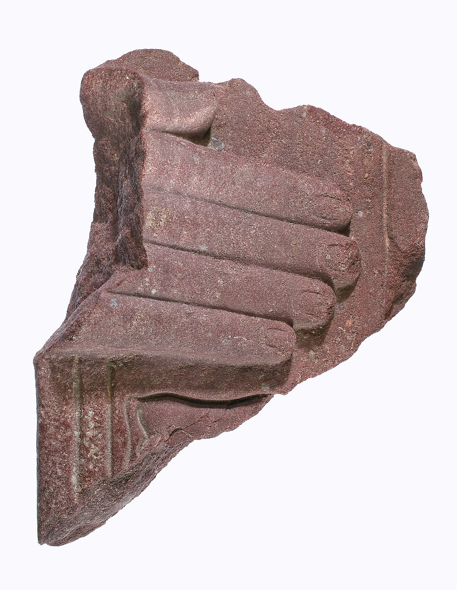 Hand from a stelophorous statue with part of the Horus name of Akhenaten (?), Red quartzite 