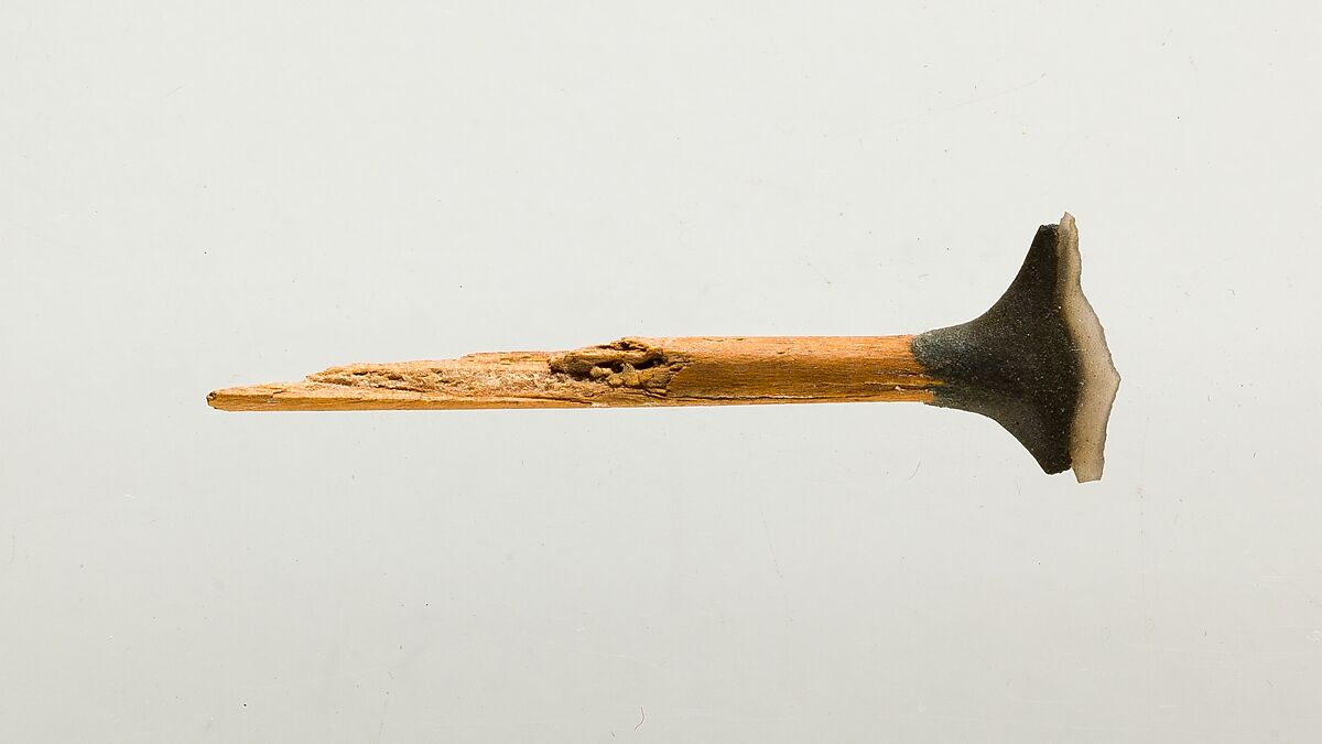 Transverse arrowhead hafted on an arrow fragment, Wood, clay, flint 