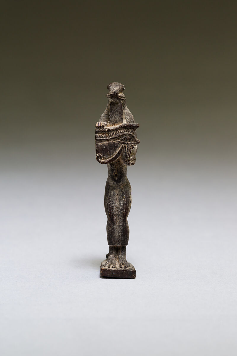 Nehebkau (snake deity) holding a wedjat eye, wood