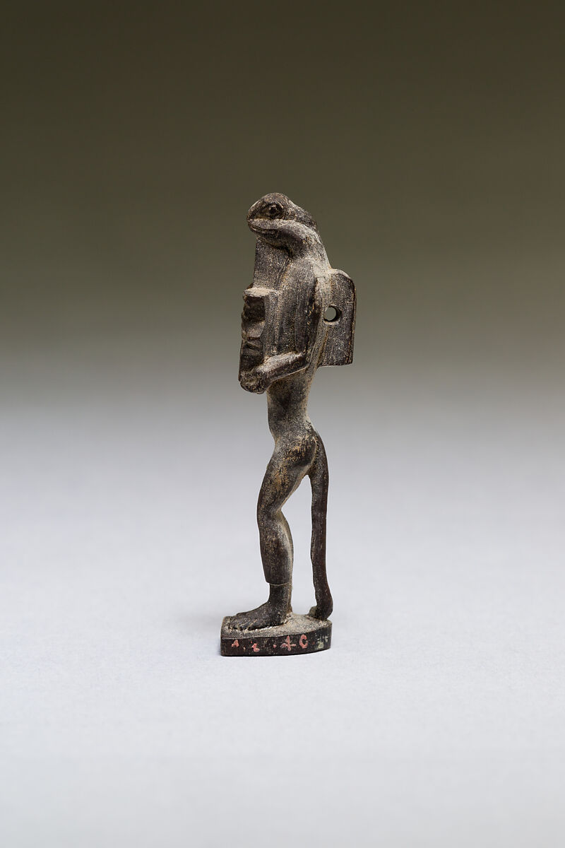 Nehebkau (snake deity) holding a wedjat eye, wood