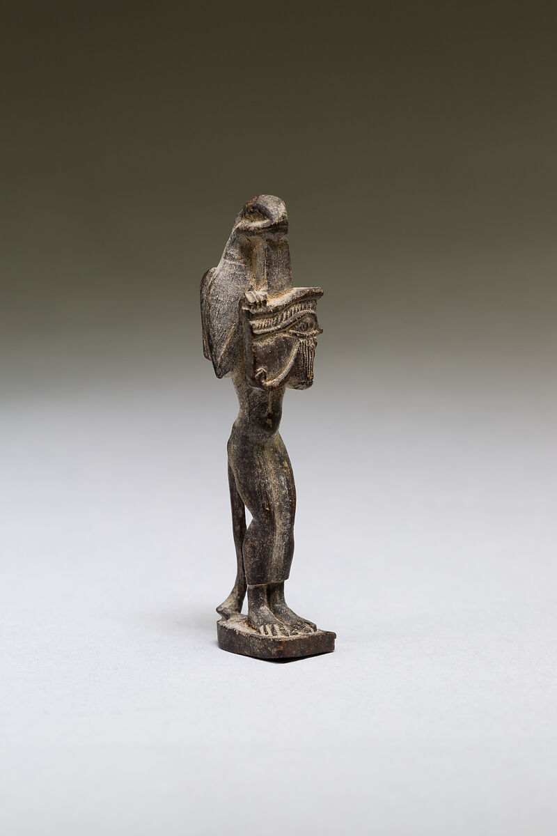 Nehebkau (snake deity) holding a wedjat eye, wood 