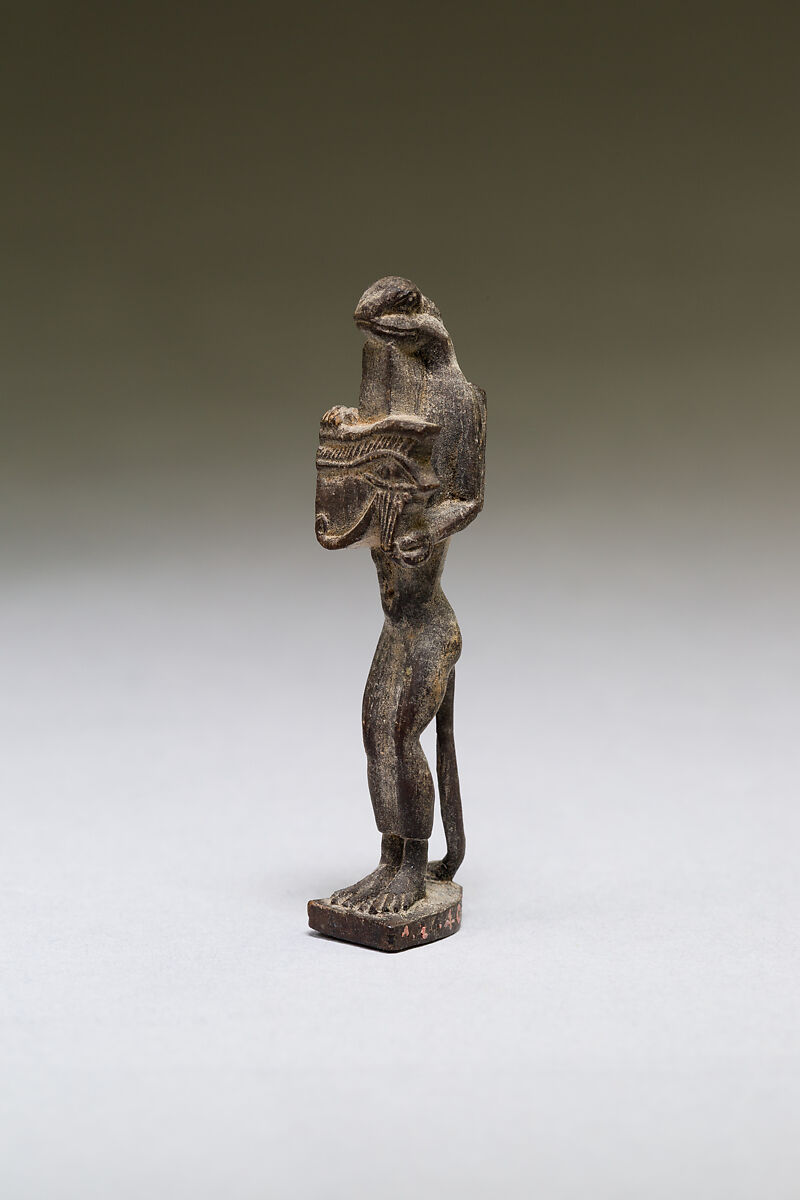 Nehebkau (snake deity) holding a wedjat eye, wood