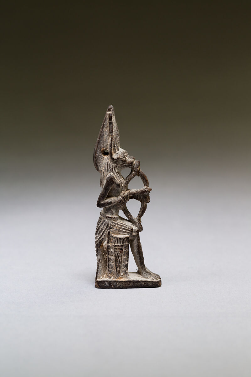 Seated polymorphic figure of jackal-headed archer, Wood