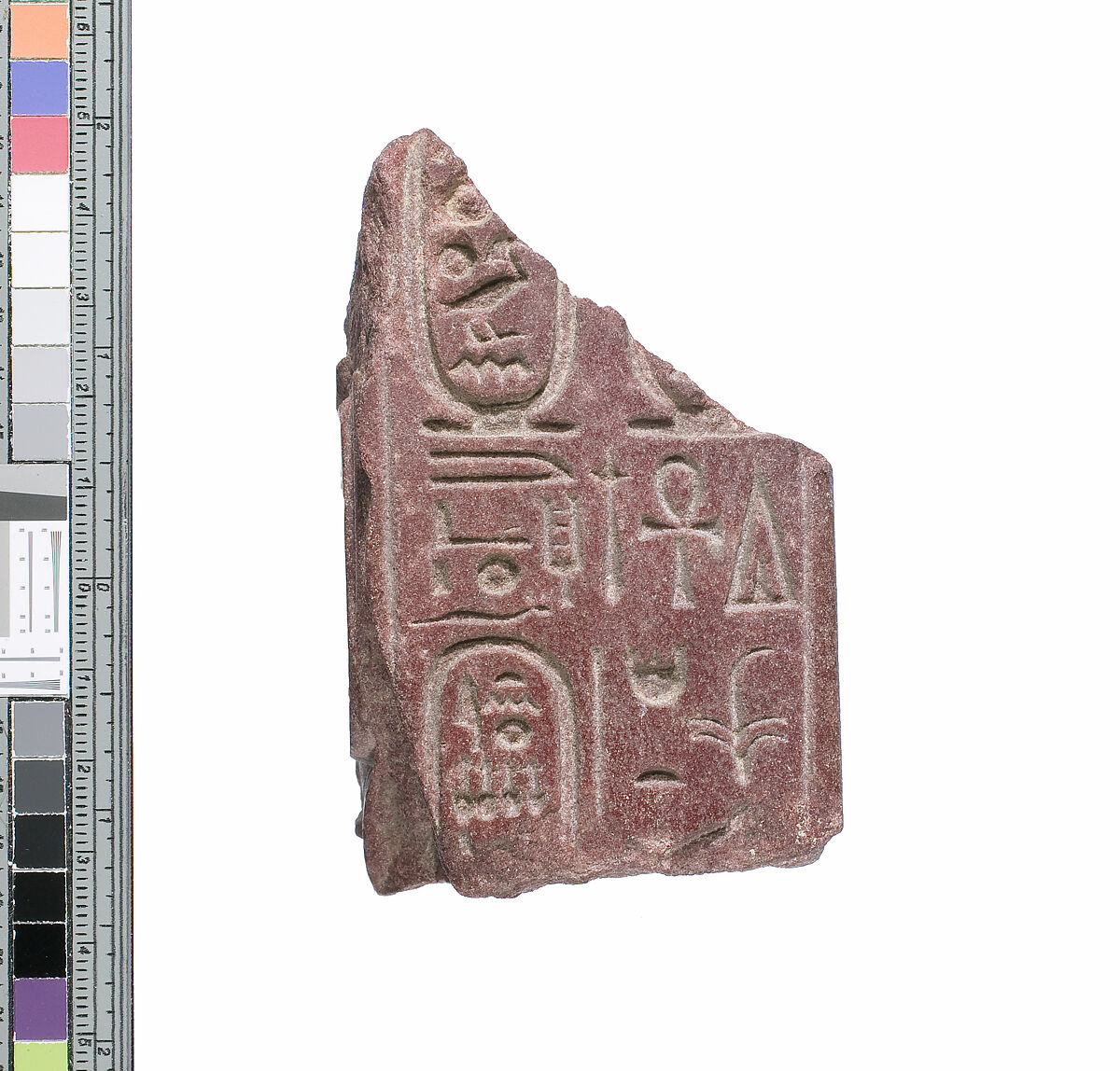 Part of a small block with names of the Aten preserved on opposite sides and names of Akhenaten and Nefertiti on one preserved end, Red quartzite