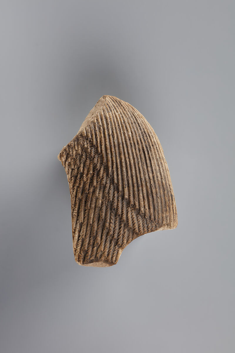 Tile fragment, part of a wig from a figure of the king, Faience
