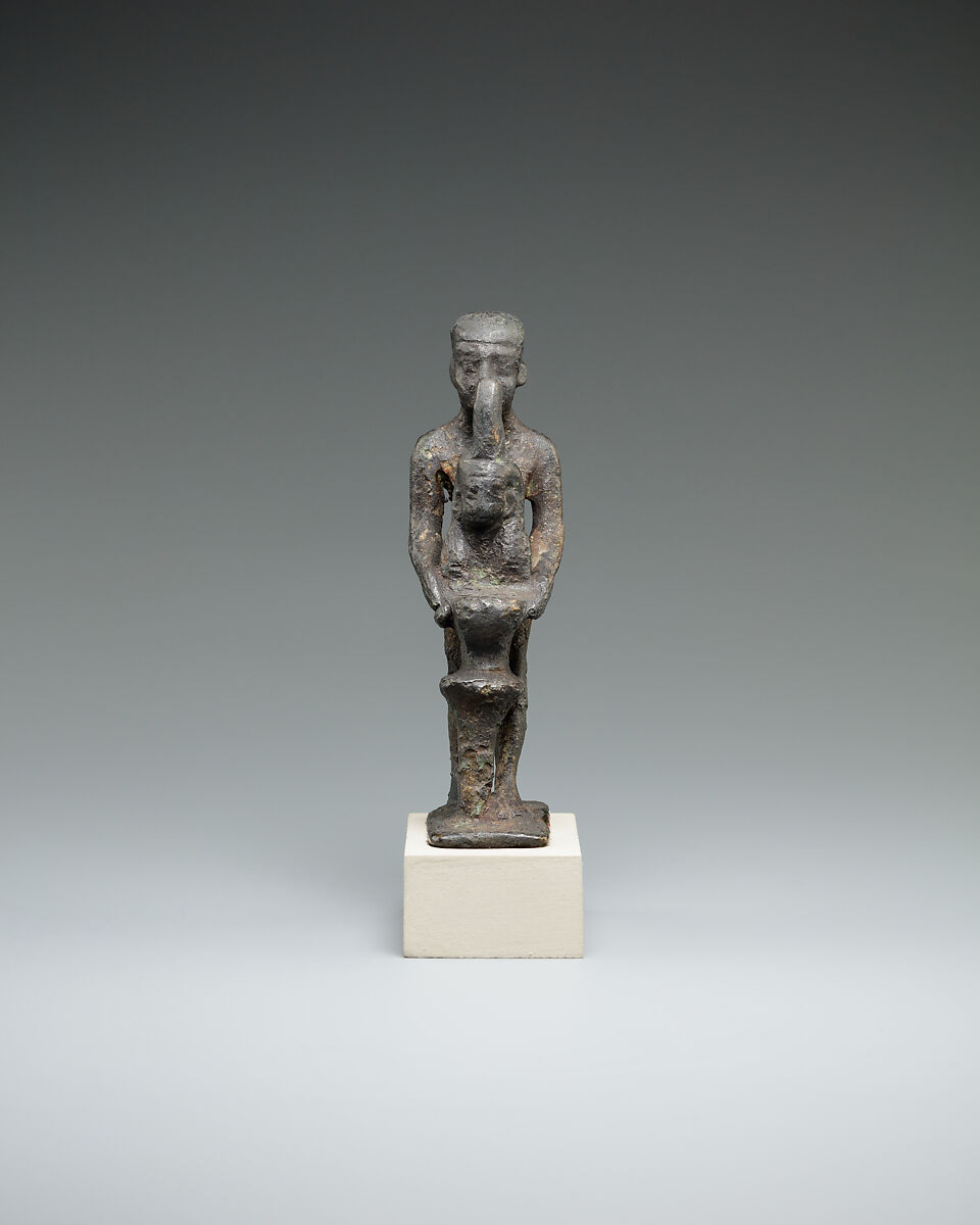 Individual holding a Maat bust on a stand, Bronze or cupreous alloy