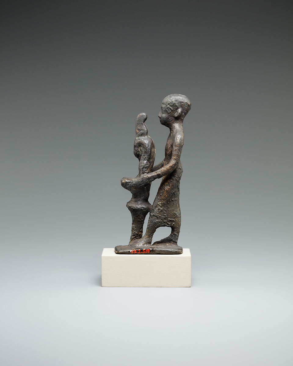 Individual holding a Maat bust on a stand, Bronze or cupreous alloy
