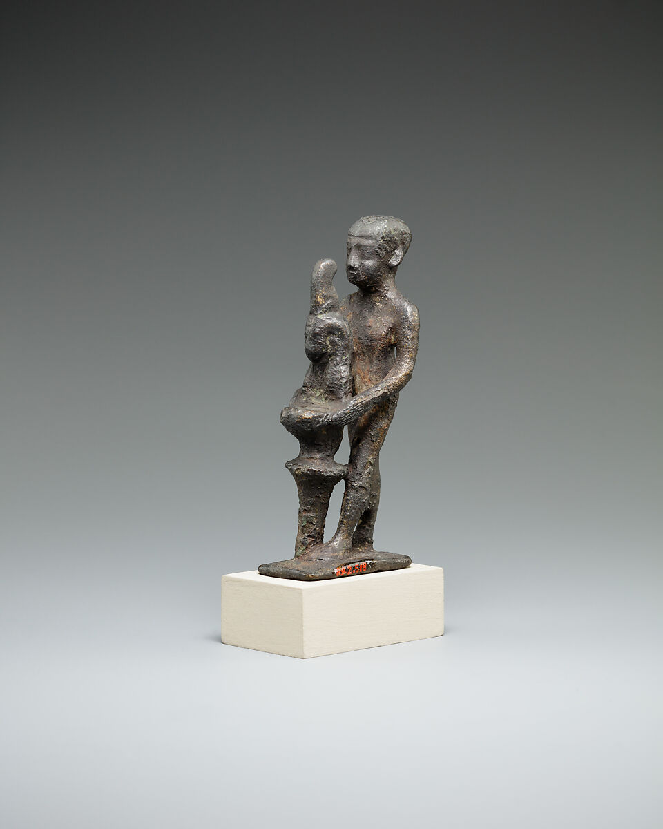 Individual holding a Maat bust on a stand, Bronze or cupreous alloy