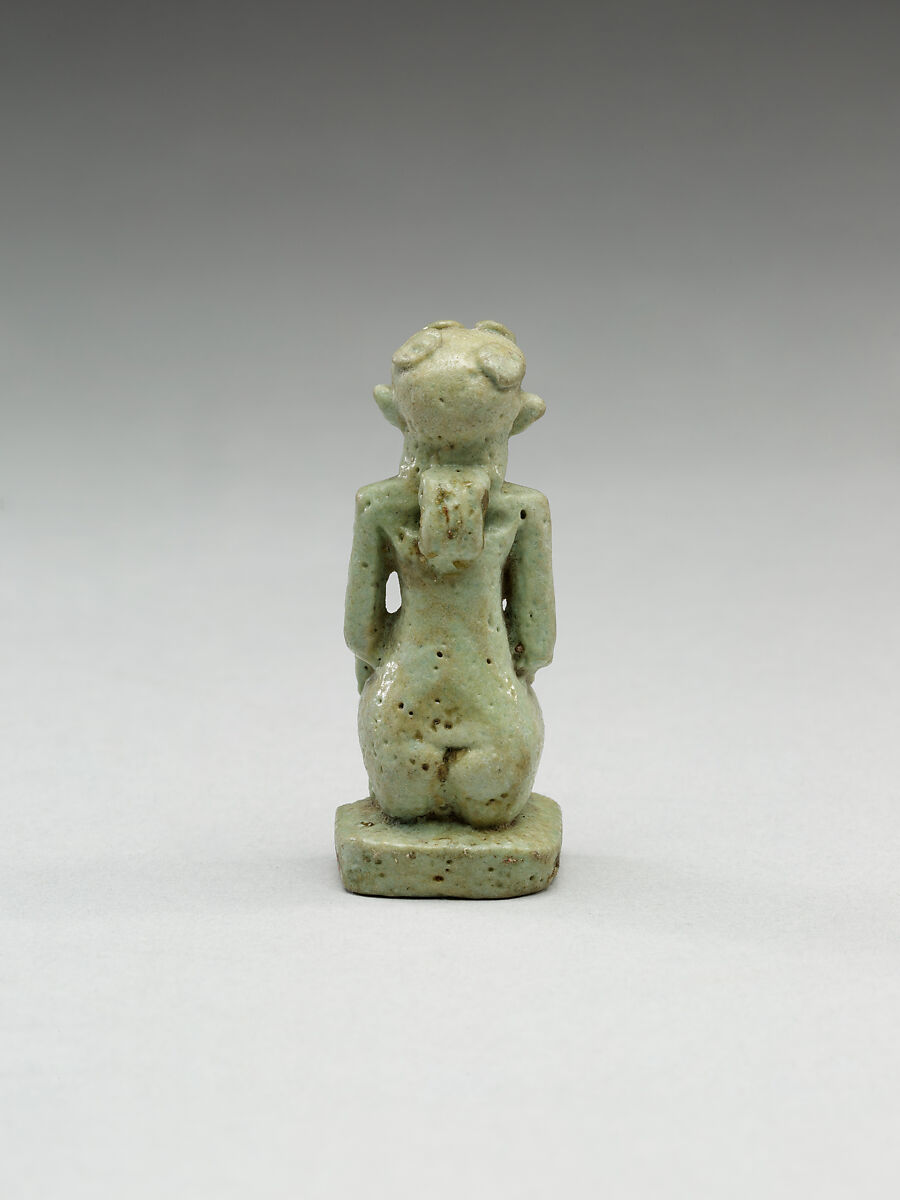 Nude crouching figure wearing a wreath, large phallus broken away, Faience