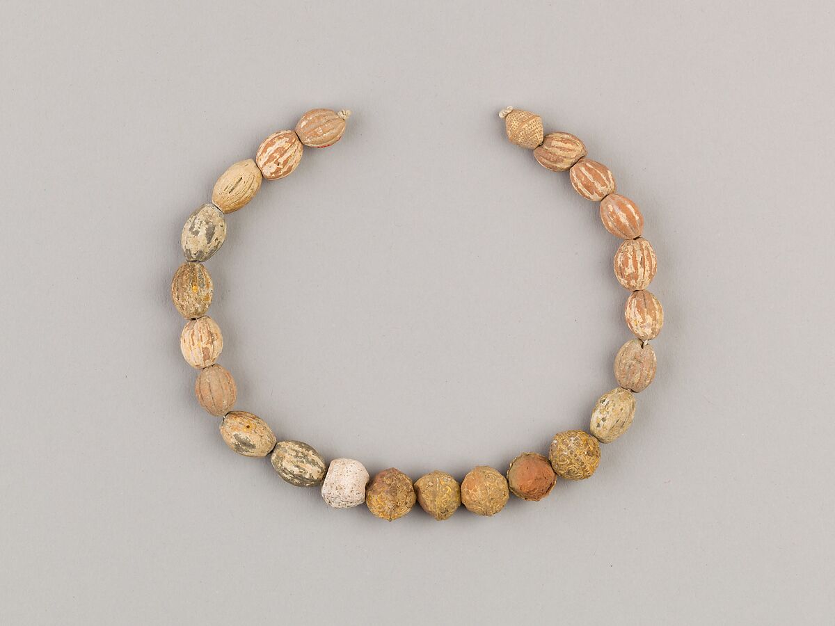 String of 23 beads, Terracotta, glassy substance 