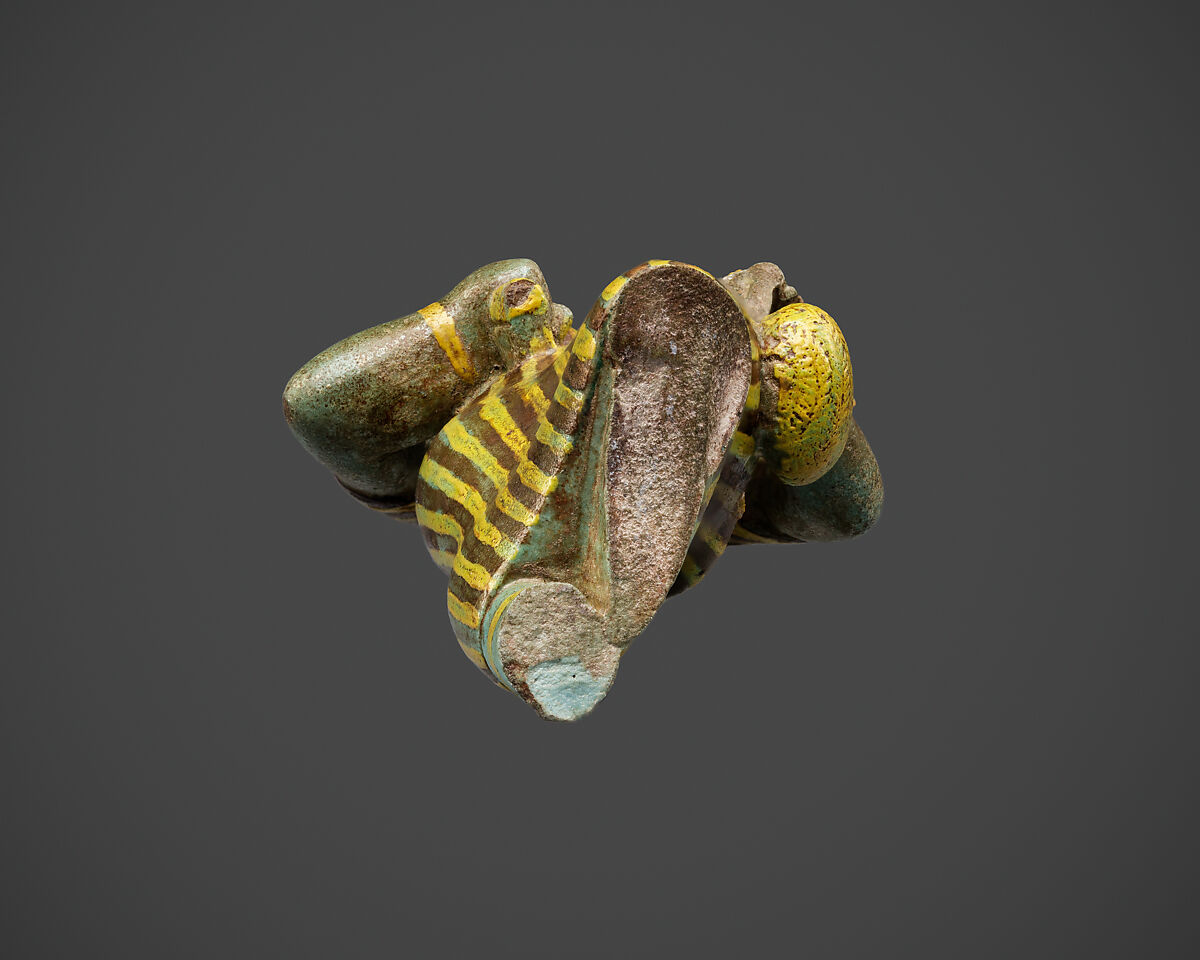 Statuette of Bastet holding a figure of Nefertum, Faience