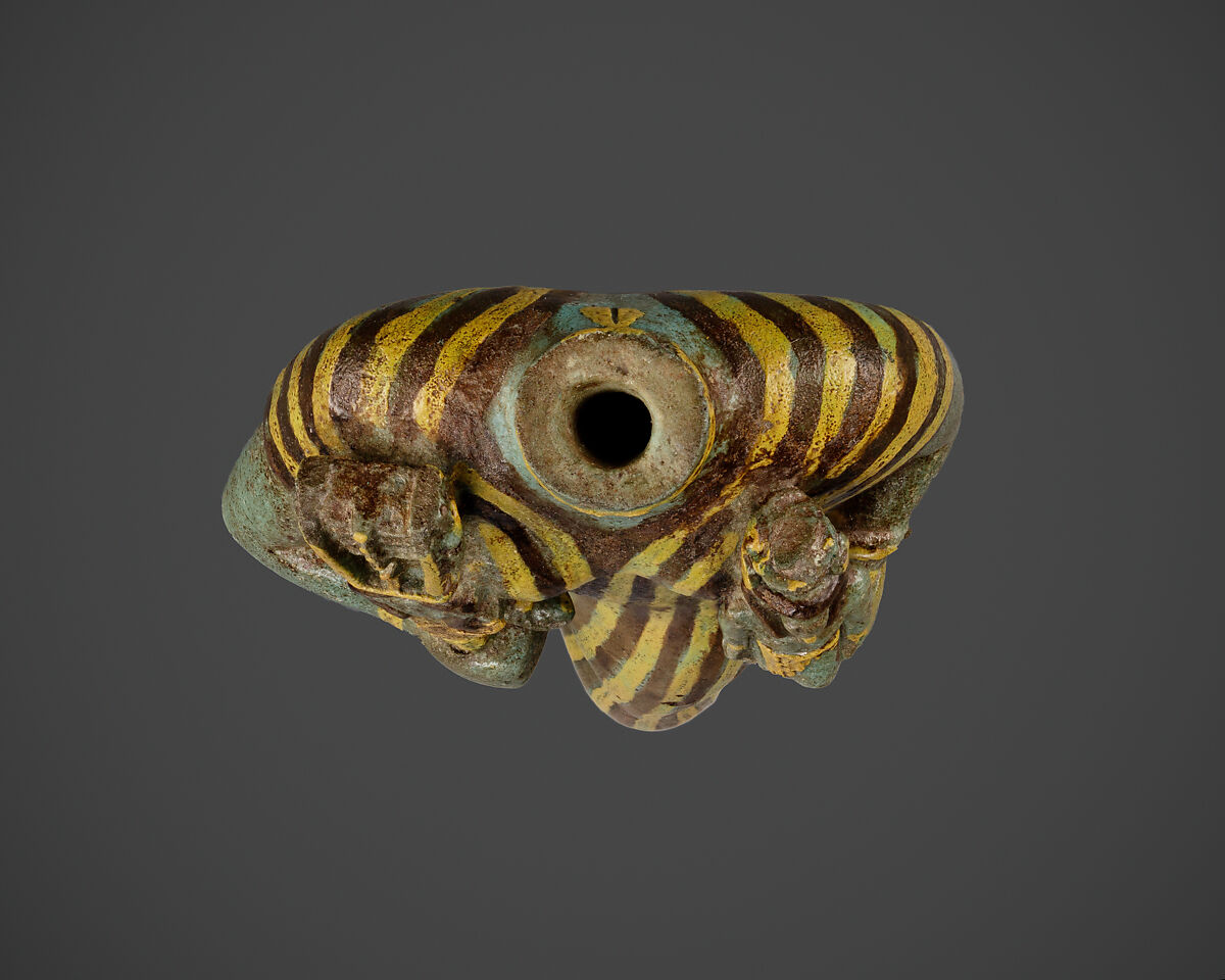 Statuette of Bastet holding a figure of Nefertum, Faience