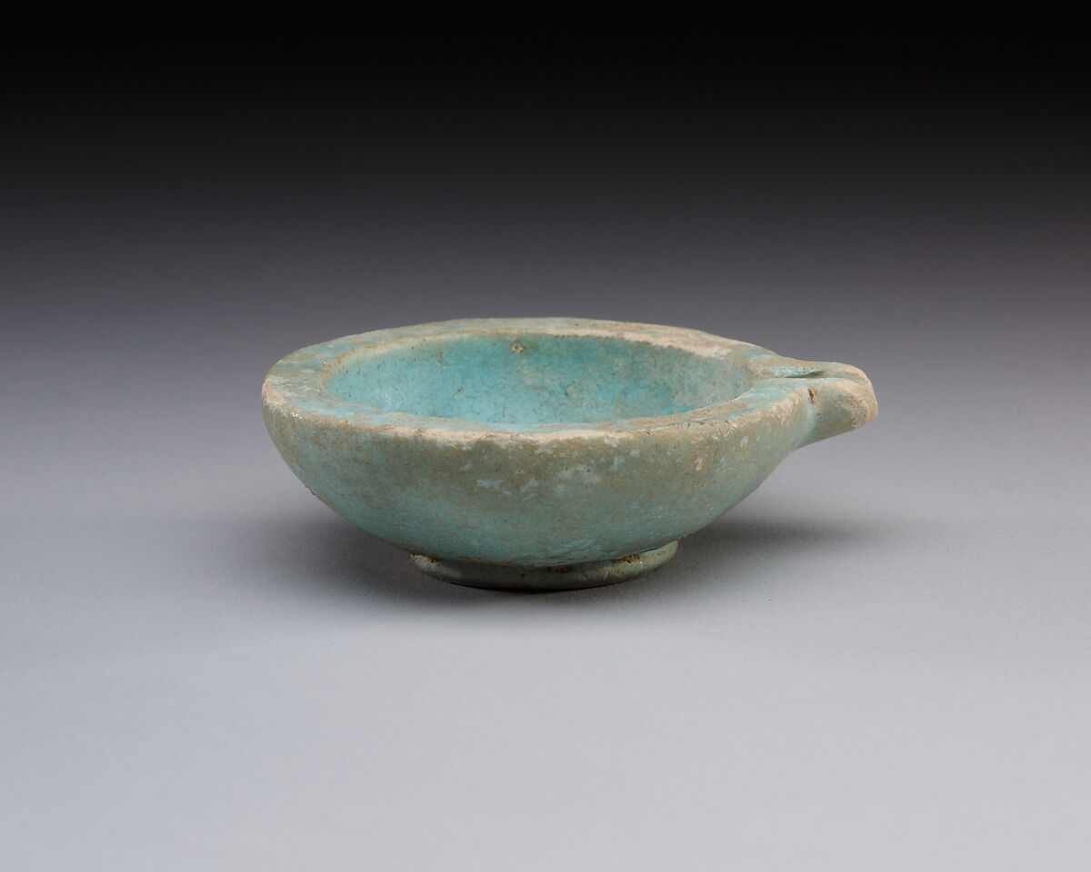 Spouted dish with rosette in the center, traces on the rim where two lions were attached, Faience 