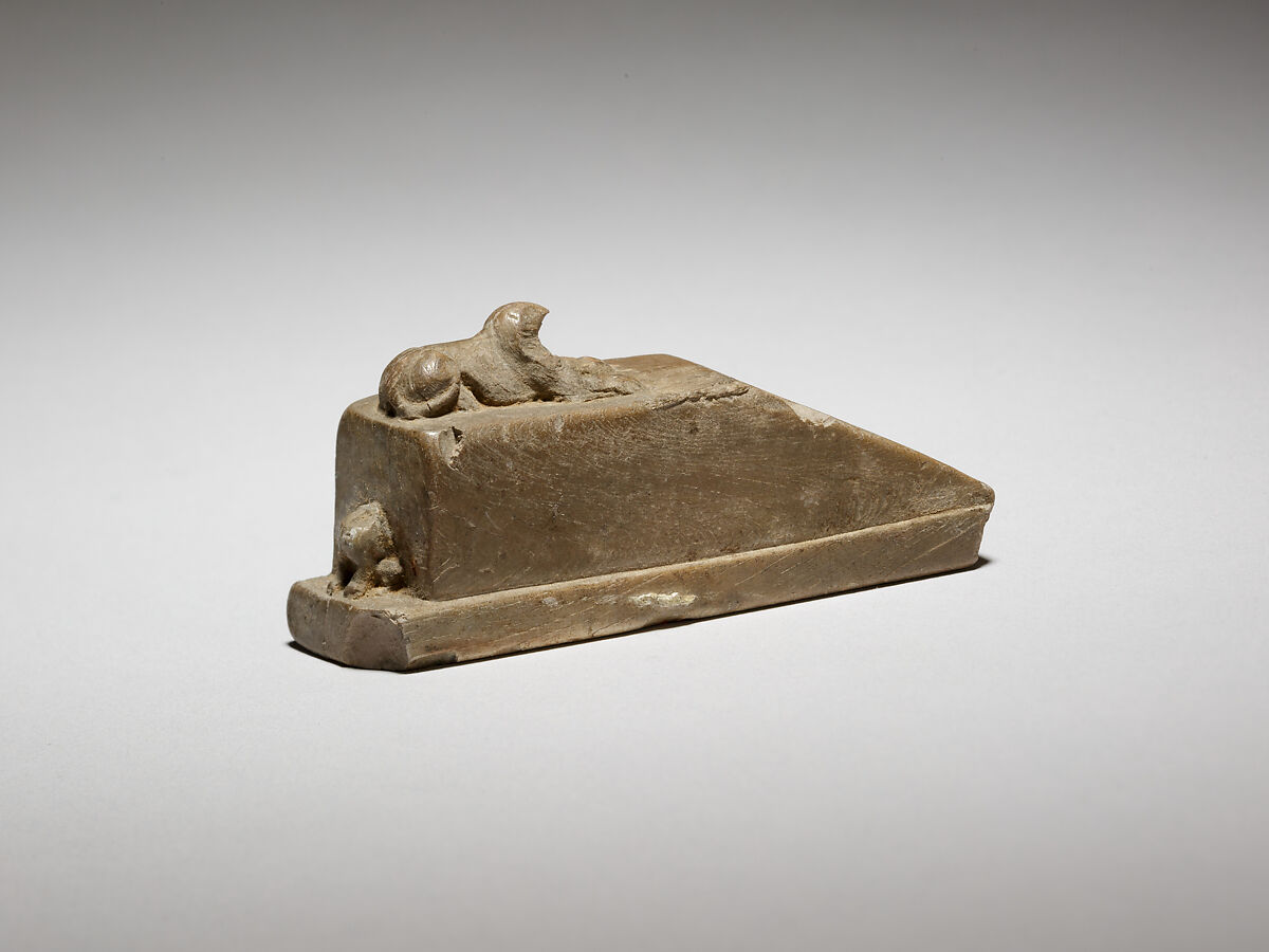 Falcon-headed sphinx recumbent on a pedestal with a ramp, and a feline(?) behind, possibly a gnomon for a shadow clock or instrument, Ivory