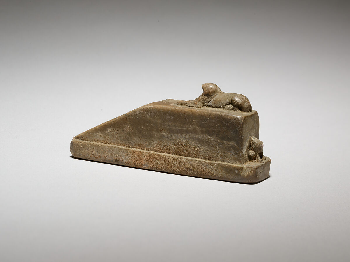 Falcon-headed sphinx recumbent on a pedestal with a ramp, and a feline(?) behind, possibly a gnomon for a shadow clock or instrument, Ivory
