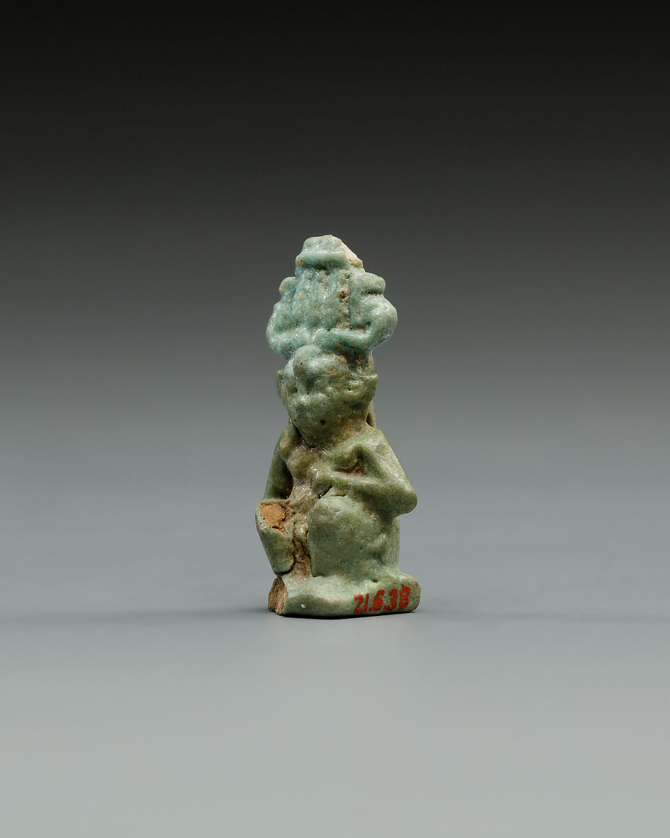 Squatting Harpokrates with hemhem and flail, Faience