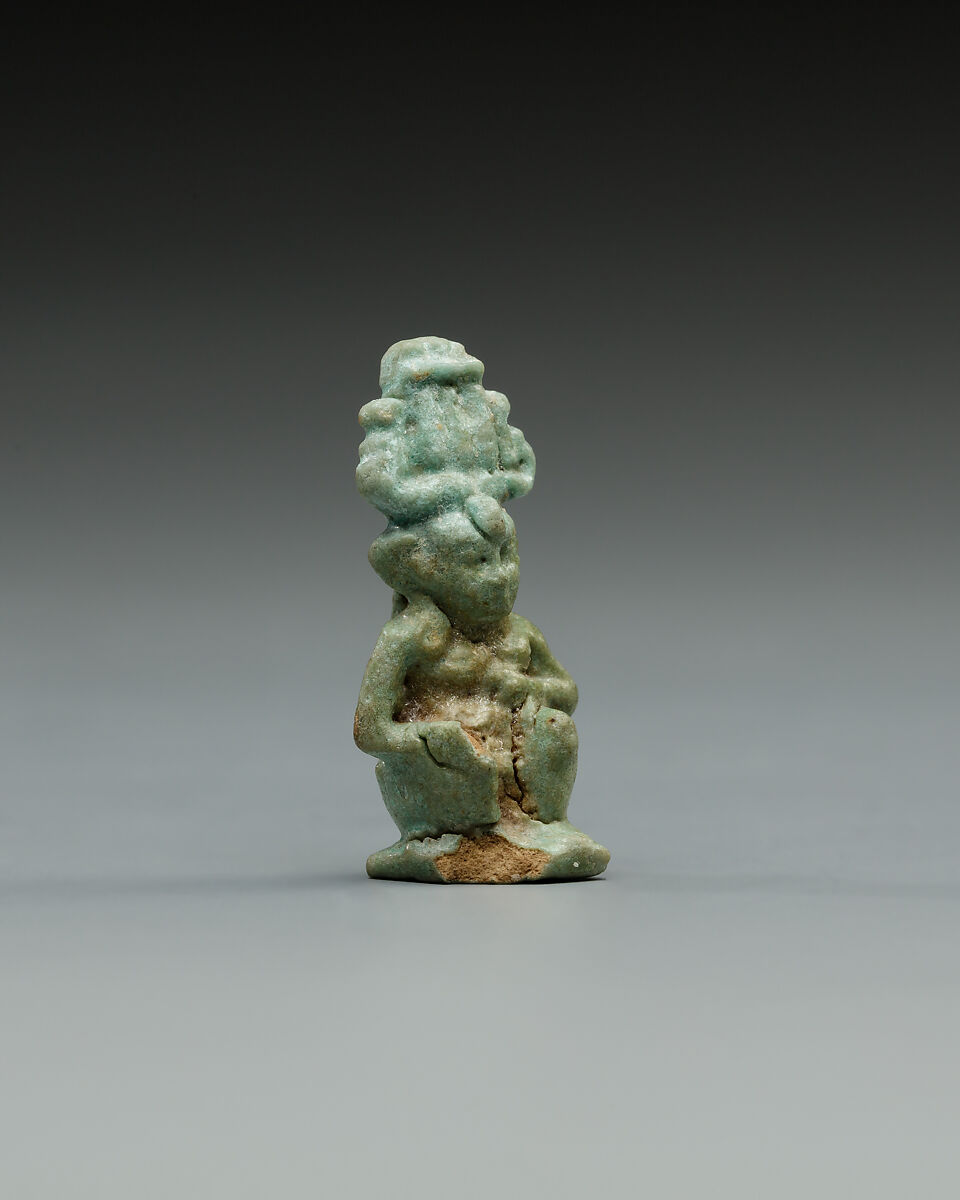 Squatting Harpokrates with hemhem and flail, Faience