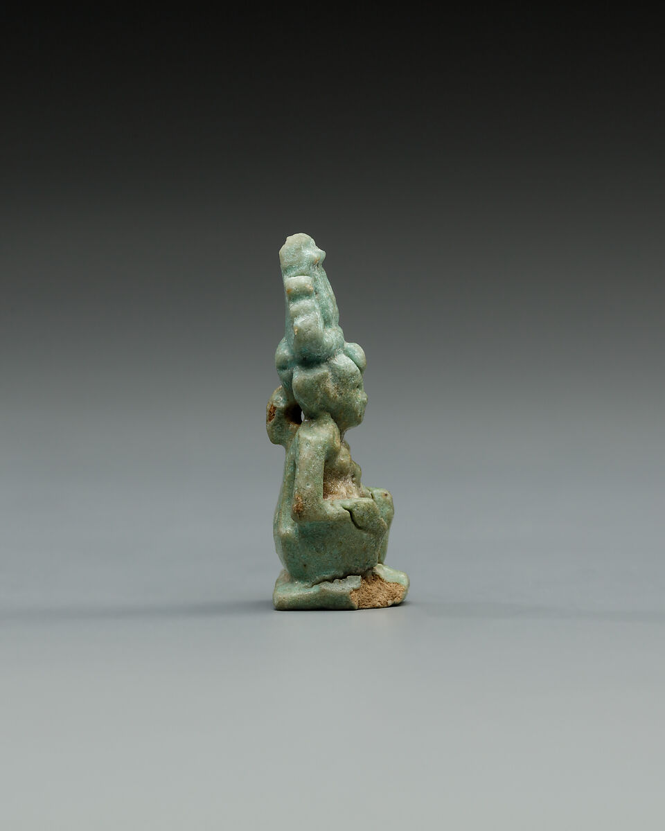 Squatting Harpokrates with hemhem and flail, Faience