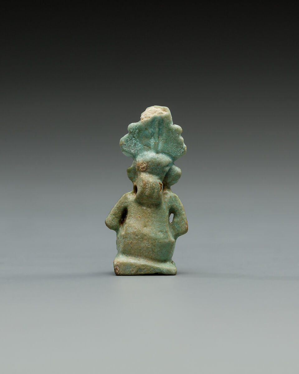 Squatting Harpokrates with hemhem and flail, Faience