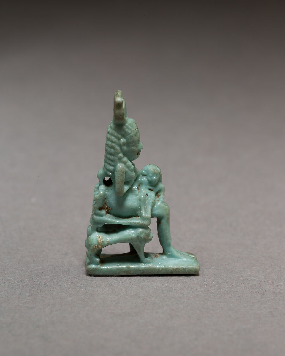 Isis nursing Horus on throne supported by striding lions, Blue faience