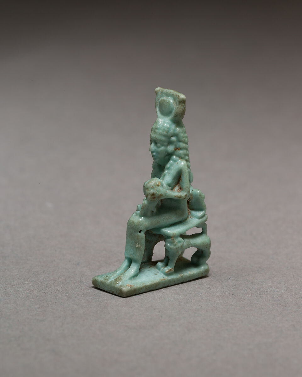 Isis nursing Horus on throne supported by striding lions, Blue faience