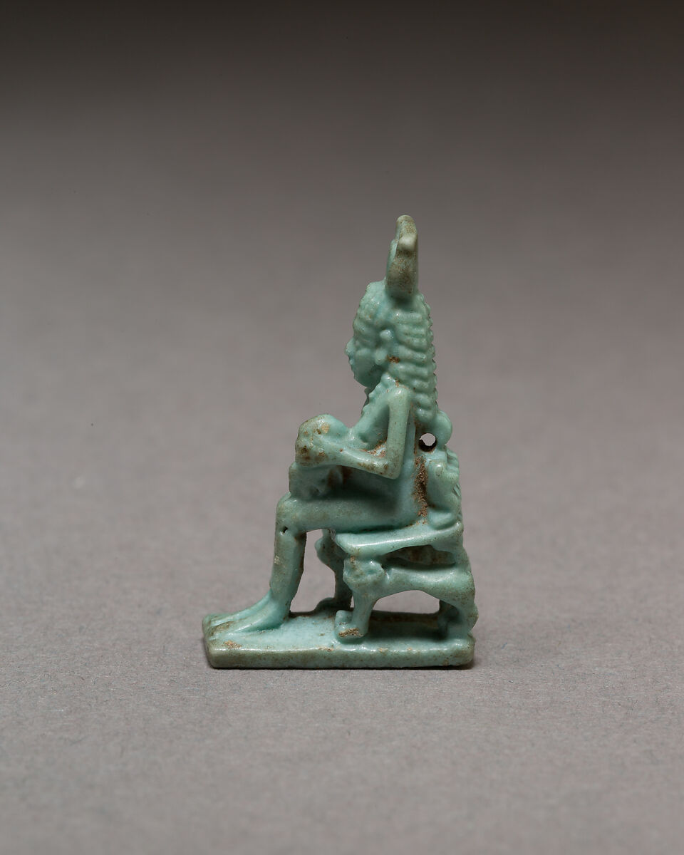 Isis nursing Horus on throne supported by striding lions, Blue faience