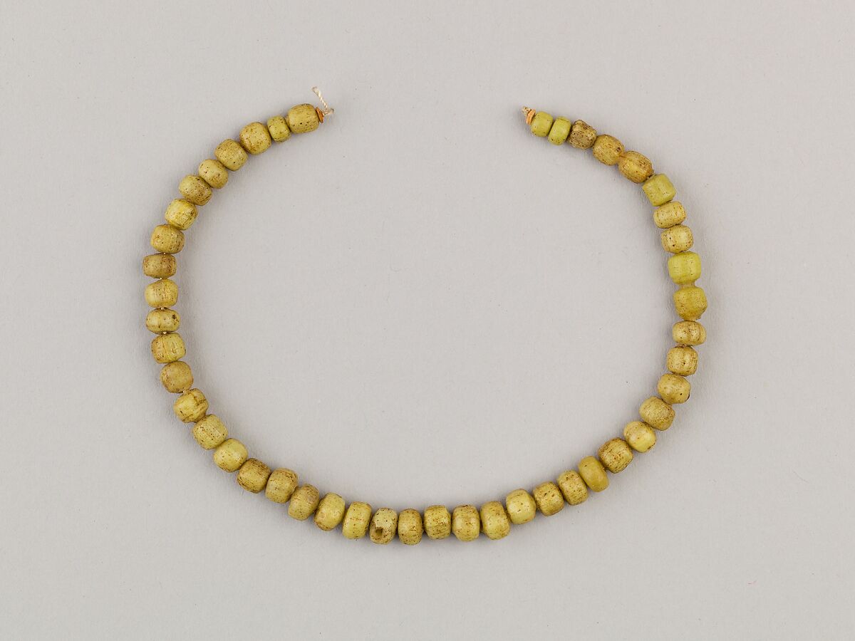String of 46 disc beads, Yellow glass 