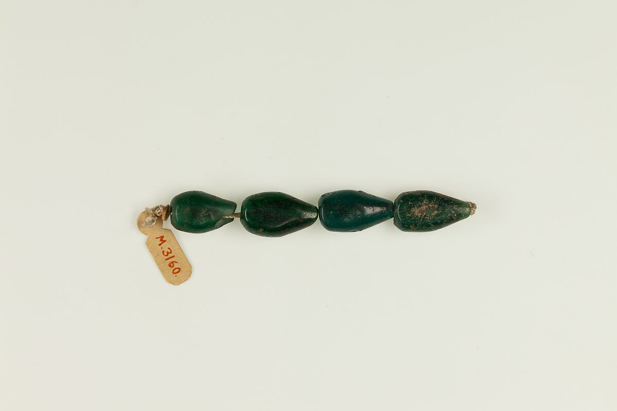 String of 4 pear-shaped beads, Translucent green glass 