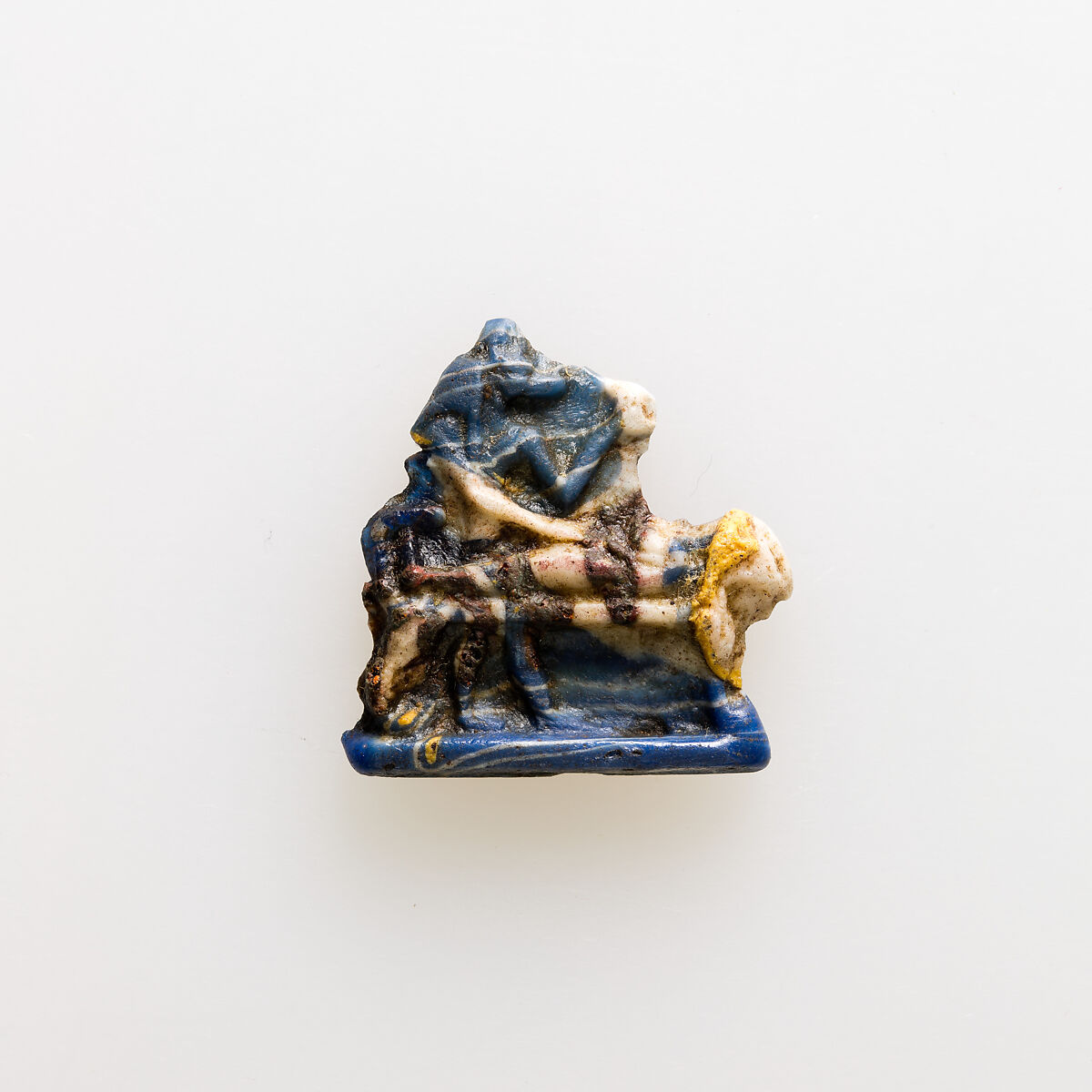 Amulet showing  Anubis standing over mummy on bier, Glass 