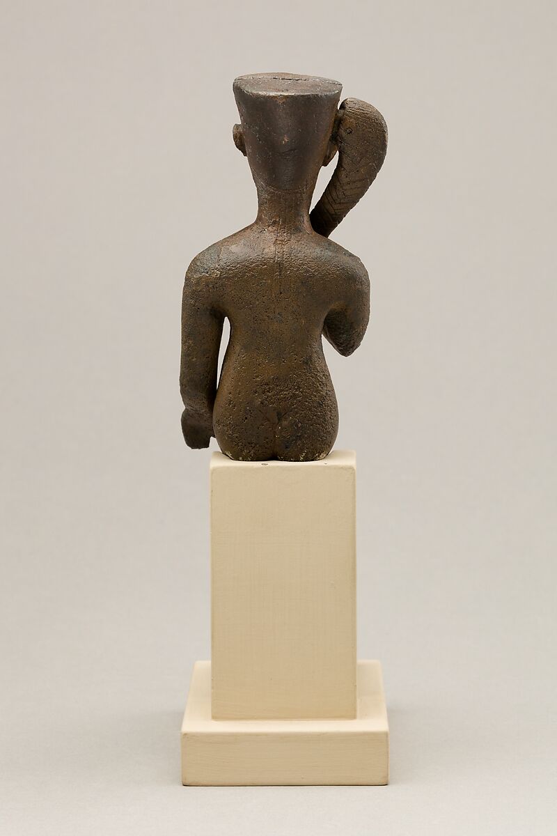 Seated Harpokrates with the crown of Amun, named as "Harpokrates-the-great, the eldest, the first of Amun", Cupreous metal, precious metal inlay