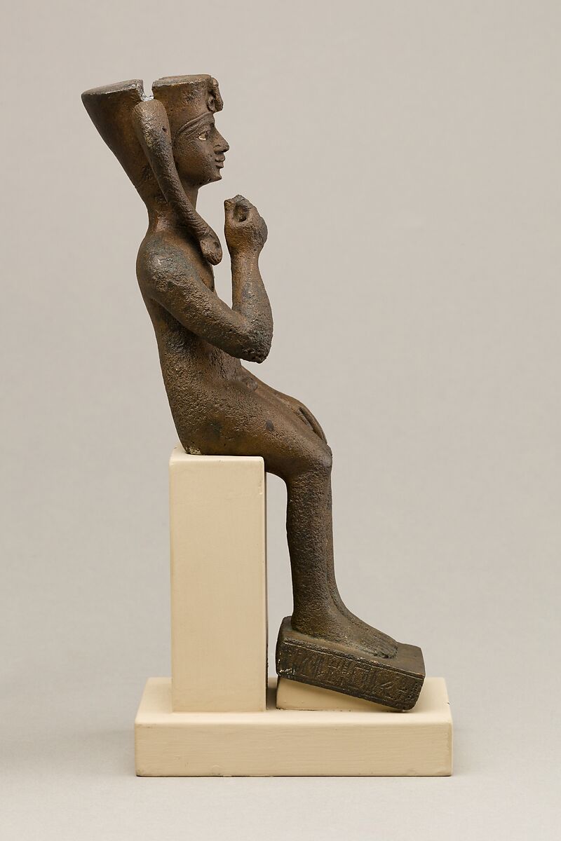 Seated Harpokrates with the crown of Amun, named as "Harpokrates-the-great, the eldest, the first of Amun", Cupreous metal, precious metal inlay