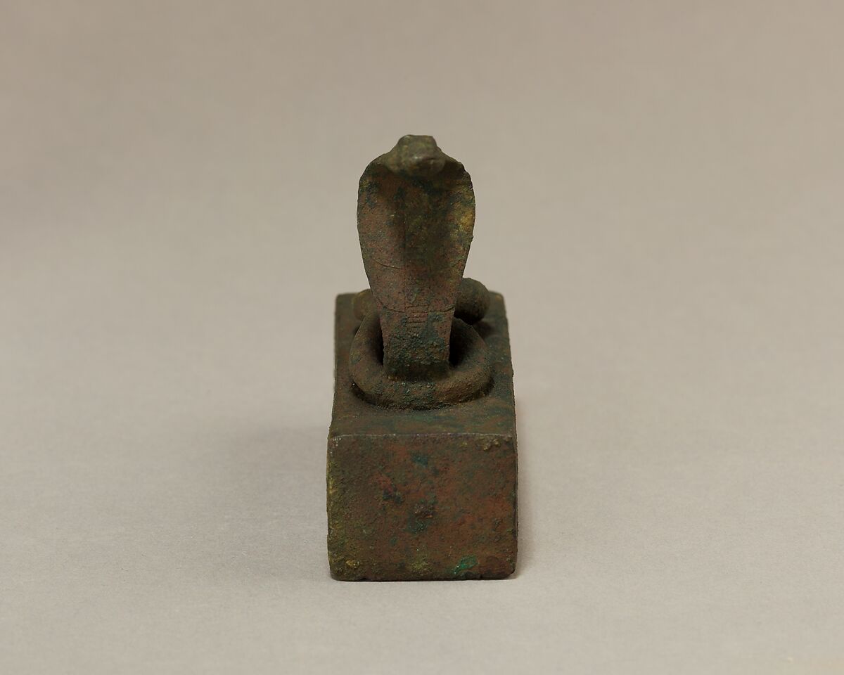 Box for an animal mummy surmounted by a coiled, rearing snake, Cupreous metal