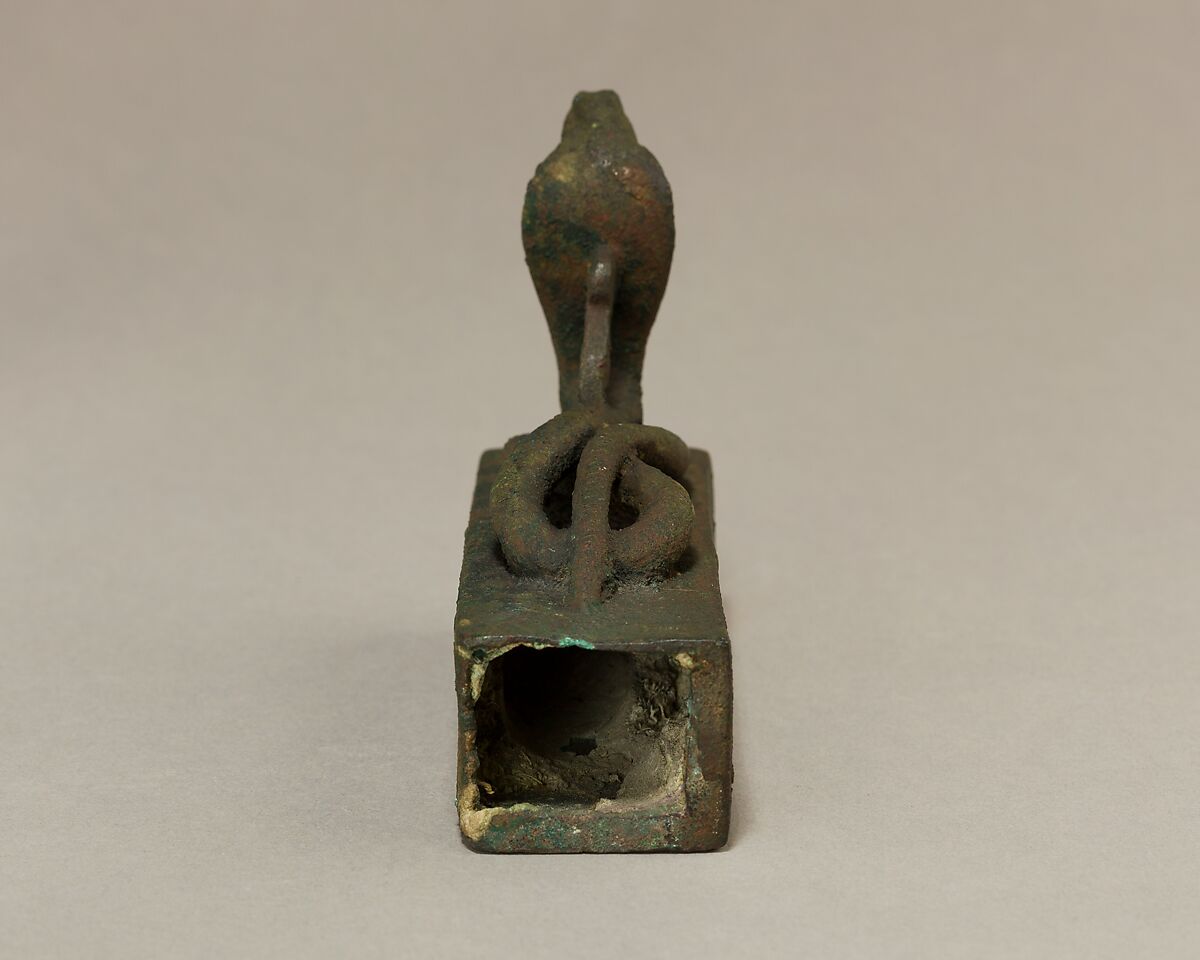 Box for an animal mummy surmounted by a coiled, rearing snake, Cupreous metal