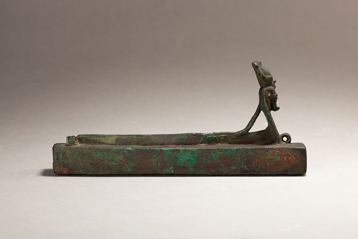 Atum as a human-headed cobra surmounting a box for an animal mummy, Cupreous metal 