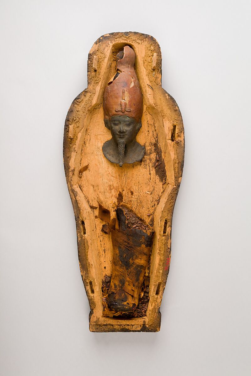Coffin and corn mummy with Osiris mask, coffin: wood, paint 
mummy: grain, sand, clay and/or soil, resin, linen bandages 
mask: wax