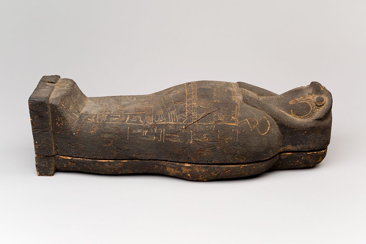 Coffin and corn mummy with Osiris mask, coffin: wood, paint 
mummy: grain, sand, clay and/or soil, resin, linen bandages 
mask: wax