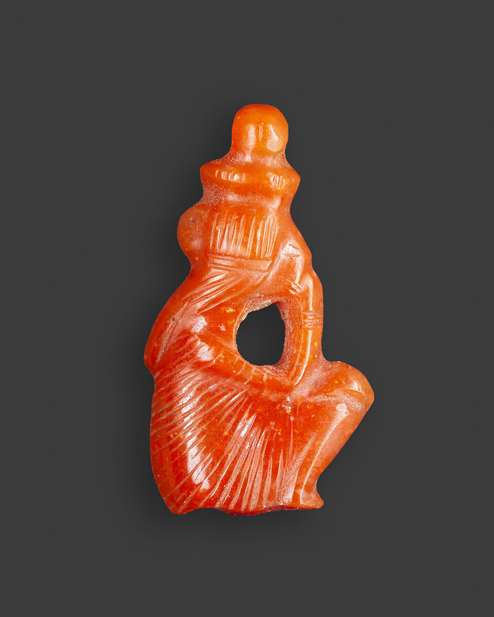 Amulet of a squatting royal female child with the name Nefertari Merimut on the underside, Carnelian 