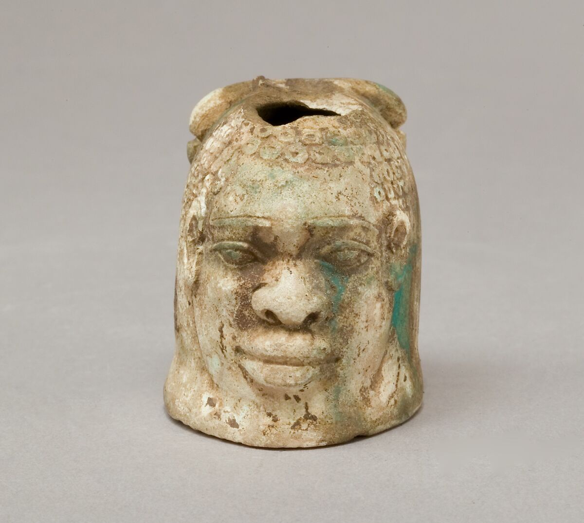 Janus-faced aryballos depicting a Nubian and a bull, Faience