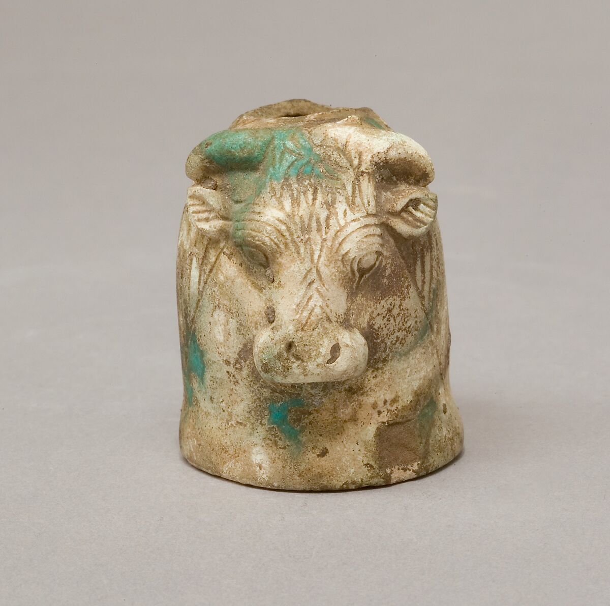 Janus-faced aryballos depicting a Nubian and a bull, Faience
