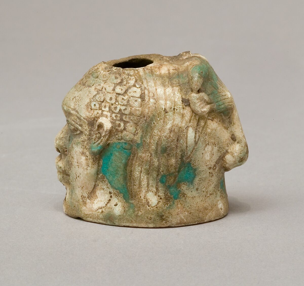 Janus-faced aryballos depicting a Nubian and a bull, Faience 