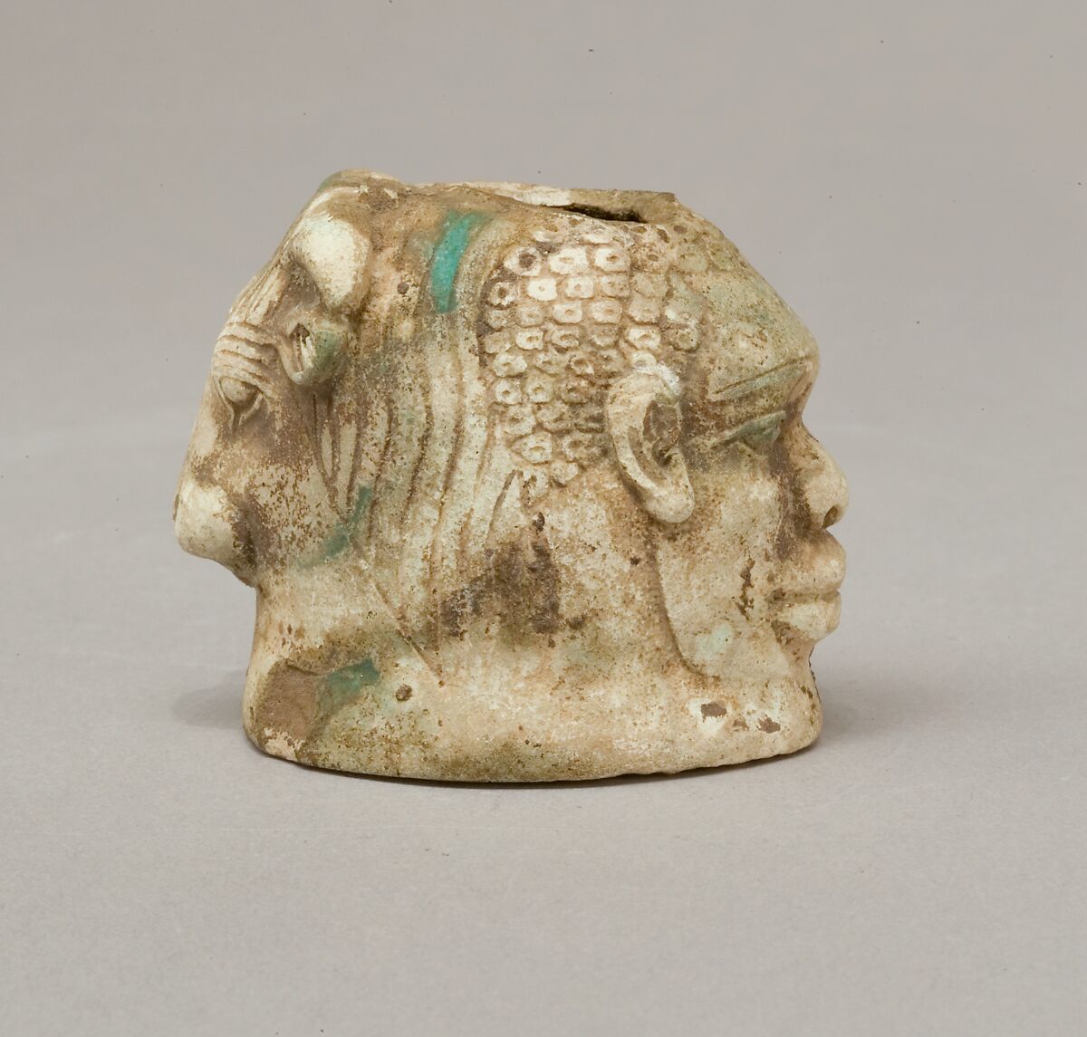 Janus-faced aryballos depicting a Nubian and a bull, Faience