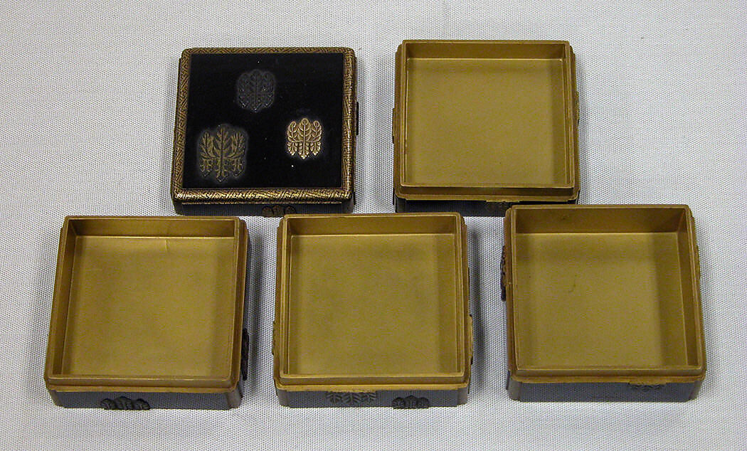 Box of Four Trays with Design of Paulownia Crest, Black lacquer with paulownia crest in applied gold, silver and copper, Japan
