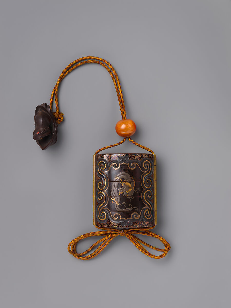 Inrō with Dragon in Cartouche on Arabesque Foliage (Karakusa) Background, Inrō: four cases; lacquered wood with gold and silver takamaki-e, hiramaki-e, togidashimaki-e, on black lacquer ground; metal cord runners; ojime: fire agate bead; netsuke: rabbit in a boat; carved wood, Japan