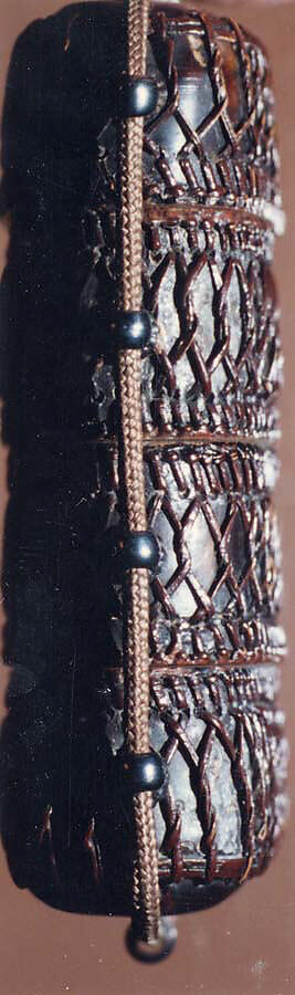 Tortoiseshell and Basketry Inrō, Three cases; tortoiseshell under plaited bamboo or rattan covered with lacquer (urushi) Netsuke: manju type, imitating basketry; stained ivory Ojime: flower; bronze, Japan