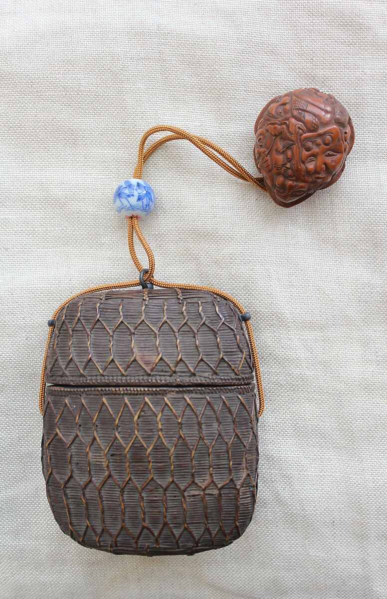 Basketry Inrō, Single case; plaited bamboo and rattan covered with lacquer (urushi) Netsuke: masks; wood, Japan 