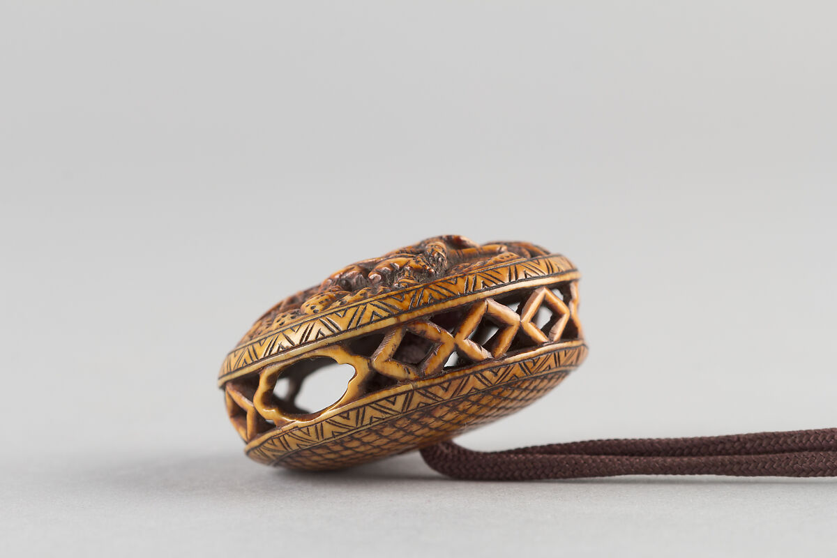 Case (Inrō) with Design of Monkey Trainer and Seated Monkey on Leash (obverse); Bundle, Hat, Sticks and Staff (reverse), Lacquer, cherry bark, gold and colored hiramakie, takamakie; Interior: plain and fundame, Japan