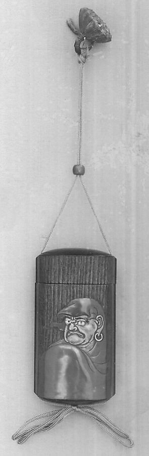 Case (Inrō) with Portrait of Daruma (obverse); Large Lotus Leaf and Stalk with Seed Pod (reverse), Brown wood, gold, brown and red hiramakie, pewter inlay, inlaid eyes; Interior: plain, covered box, Japan